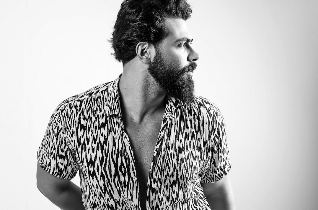 Studio portrait of a bearded man in a casual shirt