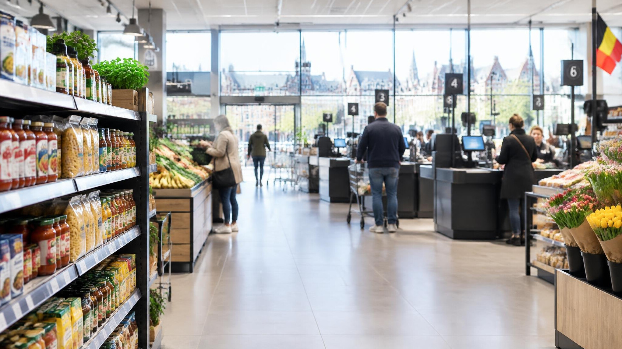 Bright modern supermarket with checkout lanes and shelves